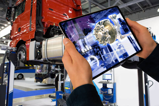 Repairing a truck using augmented reality application. Serviceman repairing a truck using augmented reality application. heavy duty truck parts stock pictures, royalty-free photos & images